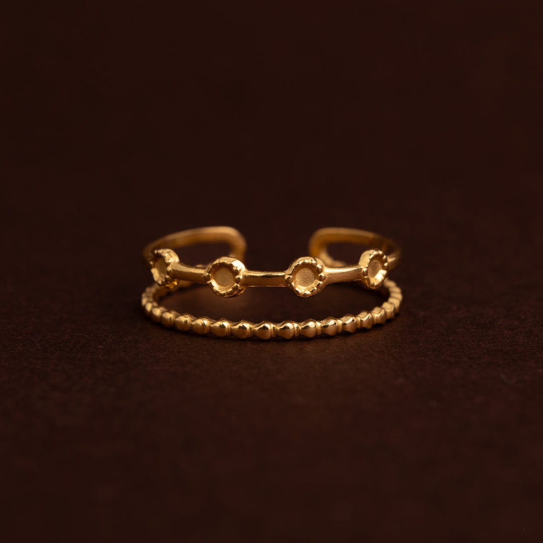 Anel dourado ajustável de fila dupla em aço inoxidável. Uma fila com textura de pequenas esferas e outra com círculos planos detalhados.